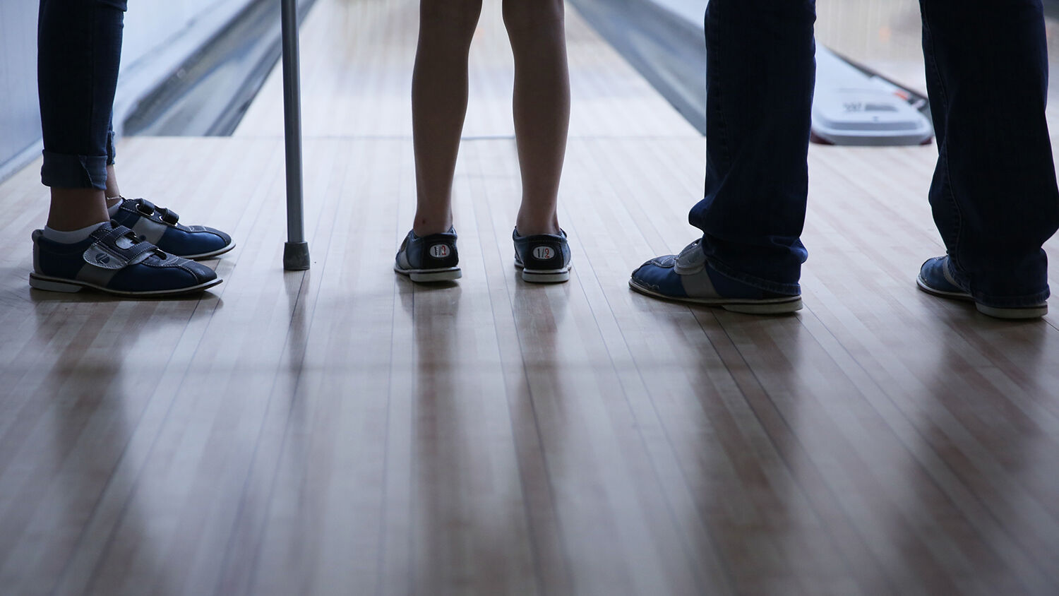 Kids, adults and helpers on the floor all played with bowling shoes